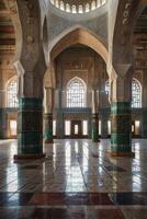 Exploring the Ornate Interior of a Grand Mosque with Detailed Columns photo
