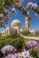 Grand Mosque in Muscat Oman with Flowers and Blue Sky photo