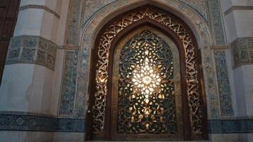 Ornate Window with Intricate Carvings and Sunlight in Historic Building photo
