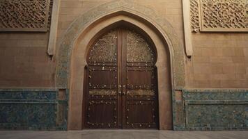 Ornate Wooden Door with Archway and Stone Wall with Geometric Designs photo
