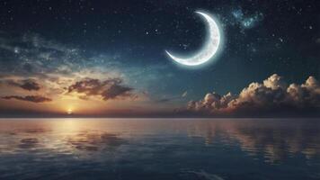 Crescent Moon Over Calm Ocean at Sunset with Stars and Clouds photo