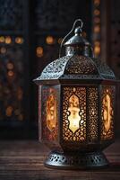 Ornate Metal Lantern with Candlelight on Wooden Surface Background photo