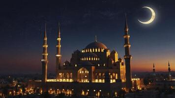 The mosque is lit up at night with a crescent moon photo