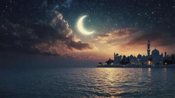 Mosque Silhouette at Night with Crescent Moon Over Ocean photo