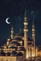 Exploring the Blue Mosque at Night with Crescent Moon and Stars photo