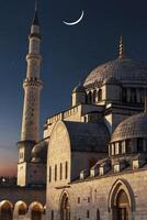 A mosque with a crescent moon in the sky photo