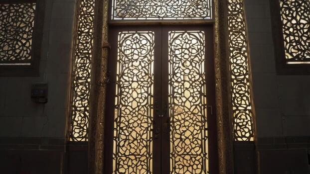 Ornate Doorway with Intricate Lattice Design and Glowing Warm Light photo