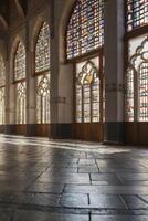 Stained Glass Window Hall with Sunlight Streaming Onto Stone Floor photo