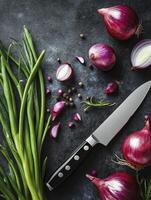 Preparing Red Onion with Fresh Herbs and Knife on Dark Surface photo