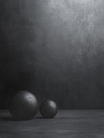 Black Spheres on Dark Background with Minimalist and Moody Studio Setting photo