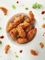 Crispy Fried Chicken Wings with Sesame Served in a Bowl photo