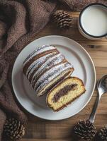 Serving Cake Roll with Milk and Pine Cones on Wooden Table photo