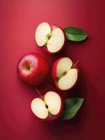 Fresh Red Apples and Halves on a Red Background for Culinary Use photo