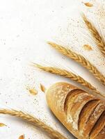 Fresh Bread Loaf with Wheat Stalks on a White Textured Background photo