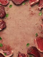 Fresh Raw Meat Steaks Arranged Around Blank Space with Basil Leaves photo