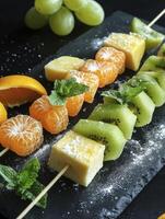 Preparing Refreshing Fruit Skewers with Kiwi, Tangerine, and Cheese photo