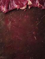 Raw Beef Meat on Dark Red Marbled Background Preparing for Cooking photo