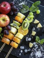 Assorted Fruit Skewers with Apple and Grapes on Black Background photo