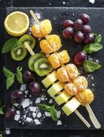 Colorful Fruit Skewers with Lemon and Grapes on Black Board photo