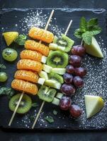Delicious Fruit Skewers with Mandarin Kiwi and Grapes on Dark Background photo