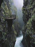 Exploring Deep Gorge with Wooden Platform and Flowing River View photo