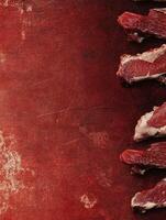 Preparing Fresh Raw Beef Ribeye Steak on Rustic Red Counter photo