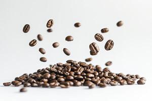 Falling Coffee Beans Creating a Pile on White Background Still Life photo