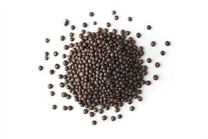 Heap of Dark Brown Seeds Scattered on White Background Overhead View photo