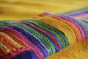 Close-up of Colorful Striped Woven Fabric on Yellow Textile Background photo
