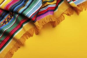 Colorful Striped Serape Blanket with Fringe on Yellow Background Flatlay photo