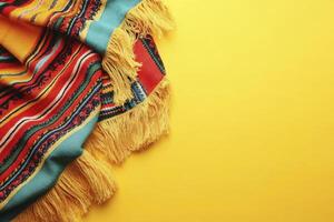 Colorful Striped Blanket with Fringes on Yellow Background for Creative Content photo