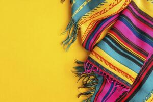 Colorful Striped Blanket with Fringes on Yellow Background for Product Display photo