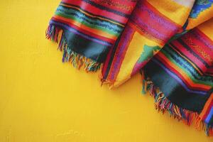 Colorful Fringed Textile on Yellow Background with Space for Text photo