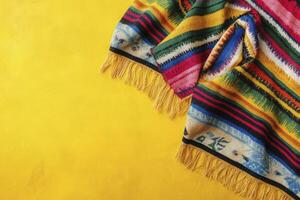 Bright Striped Blanket with Yellow Fringe on Textured Background photo