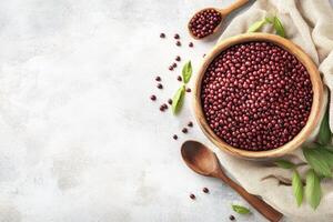 Adzuki Beans in Wooden Bowl with Spoon on Concrete Background photo
