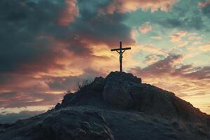 Crucifix Silhouette on Rocky Hill at Sunset with Dramatic Sky photo