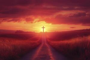Cross Silhouette Against Dramatic Sunset Sky Over Field Road photo