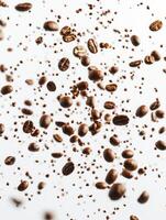 Roasted Coffee Beans Falling on White Background Creates Dynamic Pattern photo