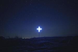 Illuminated Cross Under Starry Night Sky Atop Hill photo