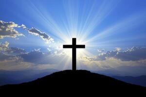 Cross Silhouette on Hill with Sun Rays Symbolizing Hope and Faith photo