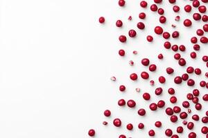 Scattered Red Cranberries on White Background Overhead Food Still Life photo