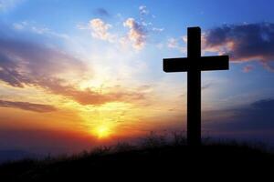 Silhouette of Christian Cross at Sunset Against Colorful Sky Background photo