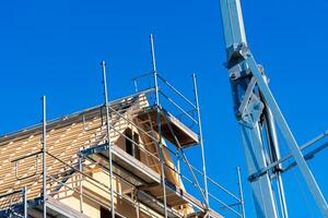 Work continues on a building under construction, featuring scaffolding photo