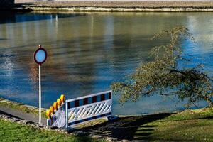 A barrier and warning sign mark restricted access along the serene photo