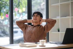 Tired experiencing neck and shoulder pain from prolonged work hours photo