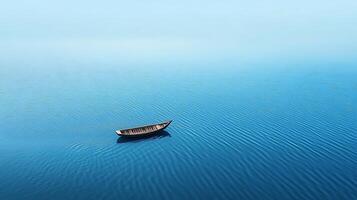 A boat floating in the middle of a blue ocean photo