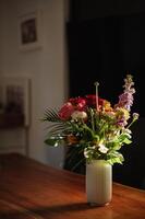 A serene interior scene with a bouquet of wildflowers catching the first rays of the day. photo