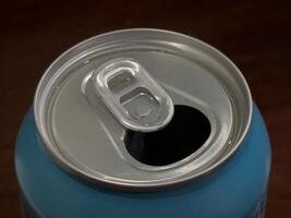 The top of an opened aluminum can with a pull-tab. photo
