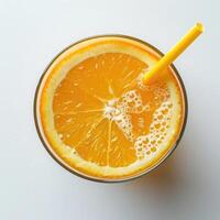 Top view of a glass of fresh orange juice with a drinking straw on an white background. Healthy Drink Rich in Vitamin C photo