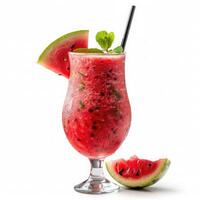 Glass of refreshing watermelon juice with mint leaves and drinking straw surrounded by sliced watermelon on white background. Healthy drink rich in vitamins photo
